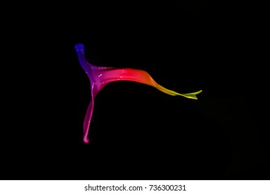 Colored paint splashes isolated on black background