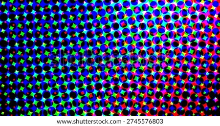 A colorful halftone pattern composed of black circles with multicolored dots in blue, green,...