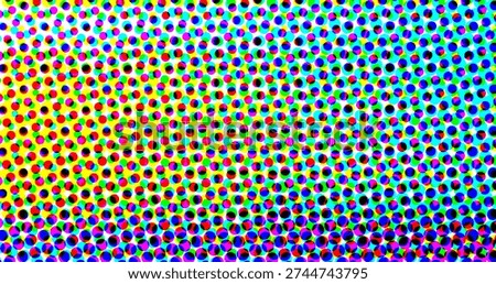 A colorful halftone pattern composed of small circles in various colors, creating a vibrant and...
