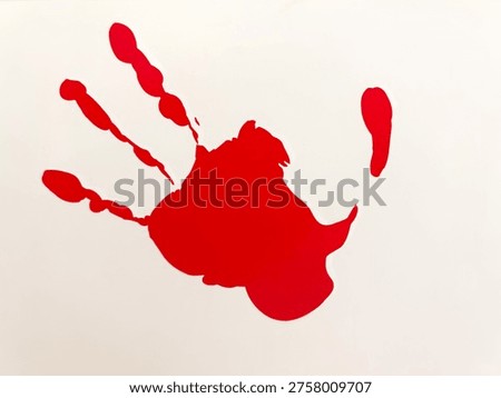 Coloured handprints are imprinted on the wall.