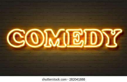 Comedy Neon Sign On Brick Wall Background