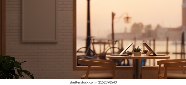 Comfortable Restaurant Or Coffee Shop Interior Design, Frame Mockup On Wall, Minimal Seating Area Near Large Glass Window With The Evening Sunlight And Blurred Outdoor View. 3d Render, 3d Illustration