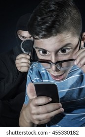 Comic Masked Man Spying Data From Smartphone Of Teenager