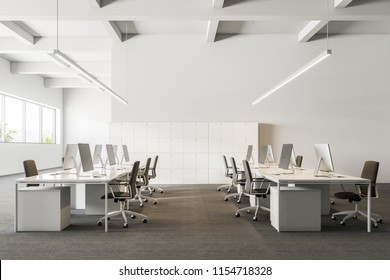 Company Office Interior With A Gray Carpet And Rows Of White Computer Desks. Industrial Style Interior With White Walls And Large Windows With A Tropical View. Lockers. Front View 3d Rendering Mock Up