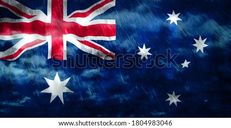 Composite of Flag of Australia and rain clouds. Symbolizing heavy rains, storms, hurricanes and other bad weather in the country. 3d illustration