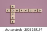 Compound Nouns. Compound Nouns concept in English grammar education. Wooden block crossword puzzle.