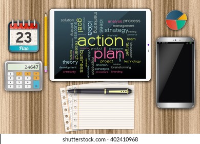 Computer tablet with an action plan. Smartphone on the wooden table.