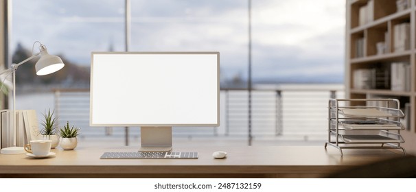 A computer with a white-screen mockup, a document shelf, a coffee cup, and a table lamp on a wooden table in a modern office with an ocean view. 3d render, 3d illustration