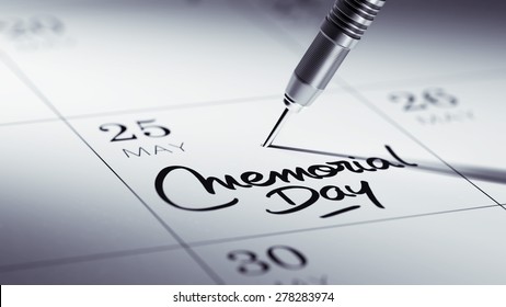 Concept image of a Calendar with a golden dart stick. The words Memorial Day written on a white notebook to remind you an important appointment.