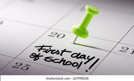 Concept Image Of A Calendar With A Shiny Green Push Pin. Closeup Shot Of A Thumbtack Attached. First Day Of School Text Note Reminder Concept. Words First Day Of School Written In Black Marker.