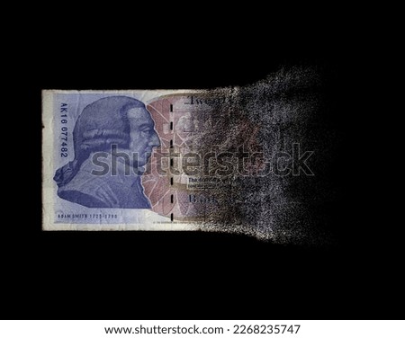A concept image showing a half dissolved flat paper UK pound bank note on a dark studio background - 3D render