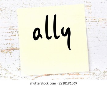 Concept Of Reminder About Ally. Yellow Sticky Sheet Of Paper On Wooden Wall With Inscription