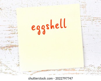 Concept Of Reminder About Eggshell. Yellow Sticky Sheet Of Paper On Wooden Wall With Inscription