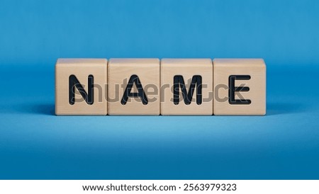 concept word name on cubes.close up of wooden elements,Business Concept.3D rendering on blue background.