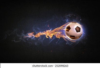 Conceptual image of football ball in fire flames