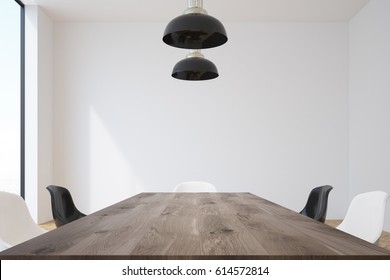 Conference Room Interior With A Long Wooden Table Surrounded By Black And White Chairs And Massive Ceiling Lamps Hanging Above It. 3d Rendering, Mock Up