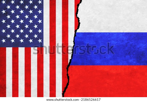 Conflict\
between Russia and USA. United States of America and Russia flags\
on a wall with a crack. USA versus\
Russia