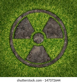 Contaminated Soil Concept With A Green Grass And The Radio Active Symbol Embossed In The Ground Exposing The Poisoned Earth As An Icon Of Environmental Disaster After A Nuclear Disaster Fallout.