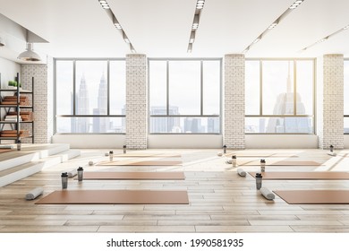 Contemporary Concrete Yoga Gym Interior With Equipment, Daylight And Wooden Flooring. Healthy Lifestyle Concept. 3D Rendering