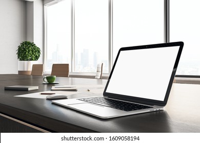 Contemporary designer desktop with blank laptop screen, coffee cup and supplies. Mock up, 3D Rendering