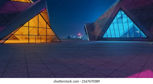 Contemporary Triangle Shape Design Modern Architecture Building Exterior With Glass, Concrete And Steel Element. Night Scene. Photorealistic 3D Rendering.