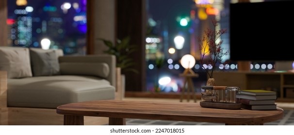 Copy space for montage your product display on wood coffee table in modern contemporary apartment living room at night with city night lights in the background. 3d rendering, 3d illustration - Powered by Shutterstock