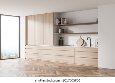 Corner Of The Light White Kitchen Interior With Parquet, Modular Cabinet, Panoramic Window, Wood And Open Shelves. Concept Of Modern House Design. 3d Rendering