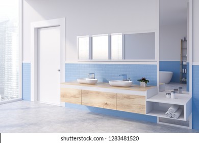 Corner of modern bathroom with white and blue brick walls, concrete floor and double sink standing on wooden countertop with horizontal and vertical mirrors. 3d rendering