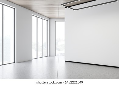 Corner Of Modern Gallery With Blank White Mock Up Wall, Concrete Floor, Wooden Ceiling And Large Windows. Concept Of Advertising. 3d Rendering