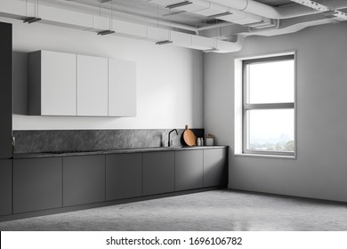 Corner Of Modern Industrial Style Kitchen With White And Grey Walls, Concrete Floor, Grey Countertops With Built In Appliances And White Cupboards. 3d Rendering