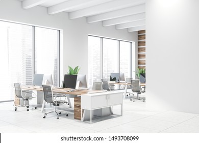 Corner Of Modern Open Space Office With Wooden Walls, Tiled Floor, Rows Of Wooden Computer Desks With Black Chairs And Mock Up Wall To The Right. 3d Rendering