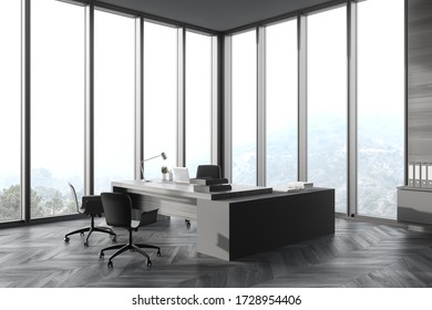 Corner Of Panoramic CEO Office With Gray Wooden Walls, Wooden Computer Desk With Chairs For Visitors And Window With Blurry Mountain View. 3d Rendering