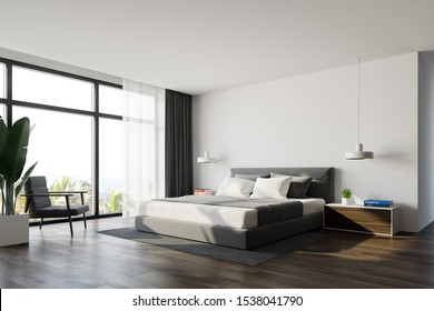 Corner of panoramic spacious bedroom with white walls, wooden floor, panoramic window with armchair near it and king size bed with two bedside tables. 3d rendering