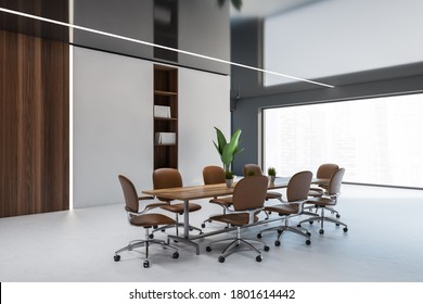 Corner Of Stylish Meeting Room With White And Dark Wooden Walls, Long Conference Table And Brown Chairs. 3d Rendering