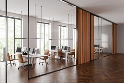 Corner Of Stylish Open Space Office Hall With White And Glass Walls, Dark Wooden Floor, Row Of Computer Tables With Brown Chairs. 3d Rendering
