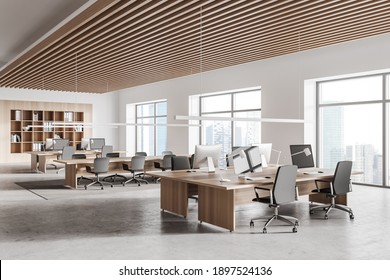 Corner Of Stylish Open Space Office With White And Wooden Walls, Concrete Floor, Row Of Computer Tables And Bookcase. 3d Rendering