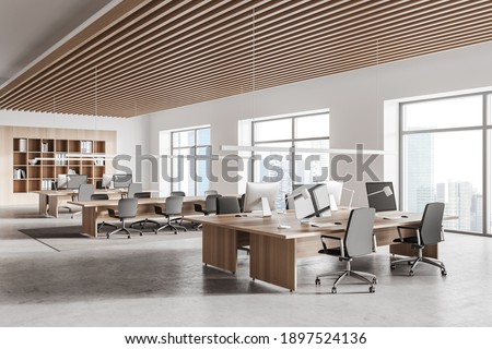 Corner of stylish open space office with white and wooden walls, concrete floor, row of computer tables and bookcase. 3d rendering