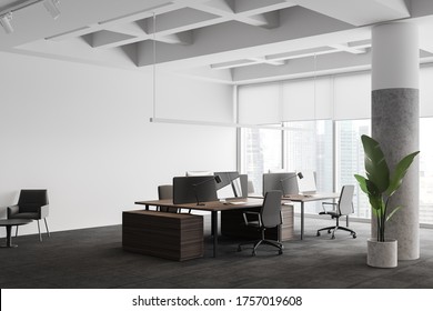 Corner Of Stylish Panoramic Open Space Office With White Walls, Carpeted Floor, Row Of Wooden Computer Tables And Lounge Area With Armchairs. Blurry Cityscape. 3d Rendering