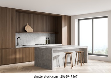 Corner view on bright kitchen room interior with two barstools, cupboard, bar counter, oak wooden parquet floor and panoramic window with countryside view. Contemporary minimalist design. 3d rendering