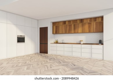 Corner View Of White Kitchen With Trendy Design, Using Modern White And Bright Wood Materials, Brick Backsplash, Copper Look Fridge And Light Parquet Floor. Minimalist Interior Concept. 3d Rendering