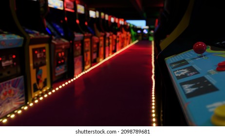 A Corridor With A Row Of Working Vintage 80's Video Arcade Machines (3D Render)