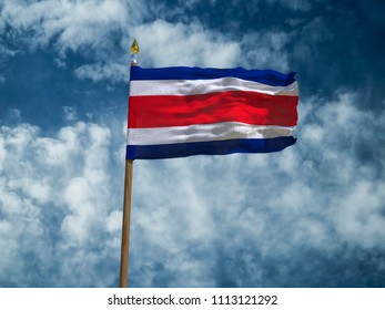 Costa Rica flag Silk waving flag of Costa Rica made transparent fabric with wooden flagpole gold spear on background blue sky white smoke clouds real retro photo Countries of world 3d illustration - Powered by Shutterstock