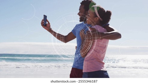 Couple on beach with smartphone, digital interface image over them. Vacation, summer, technology, augmented reality, love, leisure - Powered by Shutterstock