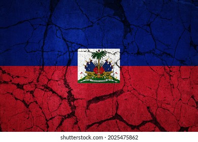 A cracked flag of Haiti. Devastation caused by major earthquake.