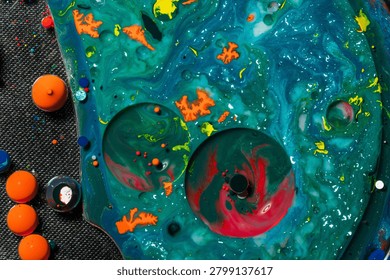 Creative abstract artwork featuring turquoise fluid textures, floating circular forms, and vibrant color accents. Perfect for science-inspired visuals, technology themes, modern backgrounds, and artistic design projects.
