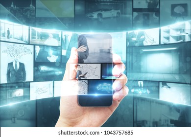 Creative digital photo gallery wallpaper. Businessman hand holding smartphone with hologram. Double exposure  - Shutterstock ID 1043757685