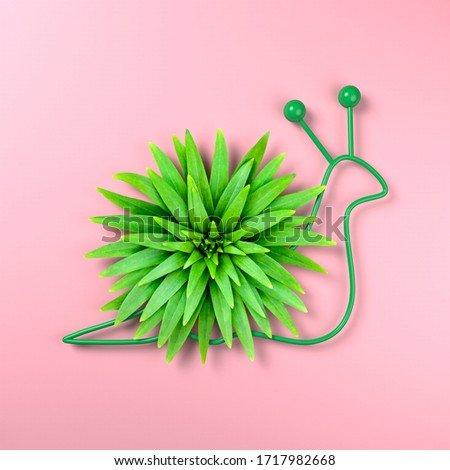 Creative image of a snail with a shell of lily leaves. An offbeat image of a clam. Pastel pink background. Minimalism style. 3d illustration.