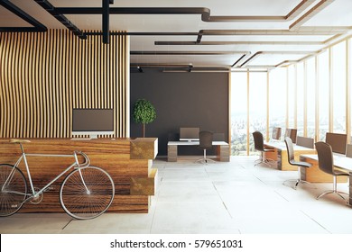 Creative office interior with bicycle, reception desk, several desks with computer monitors and panoramic city view. 3D Rendering