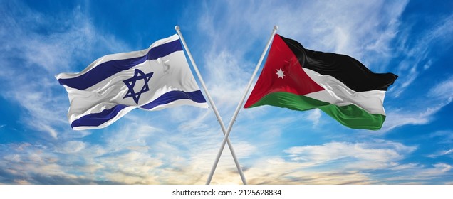 Crossed National Flags Of Israel And Jordan Flag Waving In The Wind At Cloudy Sky. Symbolizing Relationship, Dialog, Travelling Between Two Countries. Copy Space. 3d Illustration
