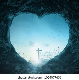 Crucifixion of Good Friday concept: Heart shape of empty tomb stone with silhouette cross over meadow night background